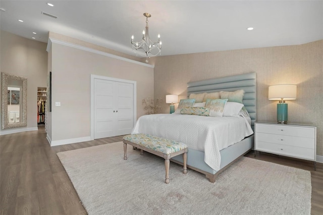 bedroom featuring hardwood / wood-style floors and a chandelier