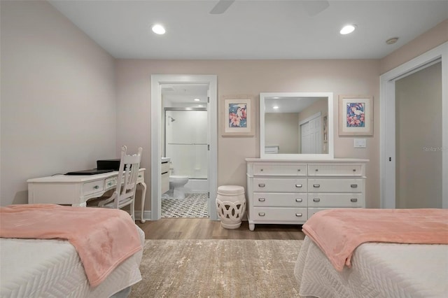 bedroom featuring ensuite bathroom and hardwood / wood-style floors