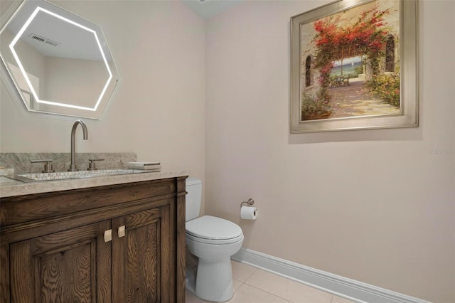 bathroom featuring vanity, tile patterned floors, and toilet