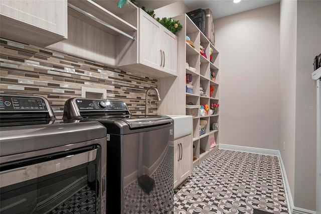 laundry room with cabinets and separate washer and dryer