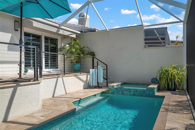 view of pool featuring an in ground hot tub, a lanai, and a patio