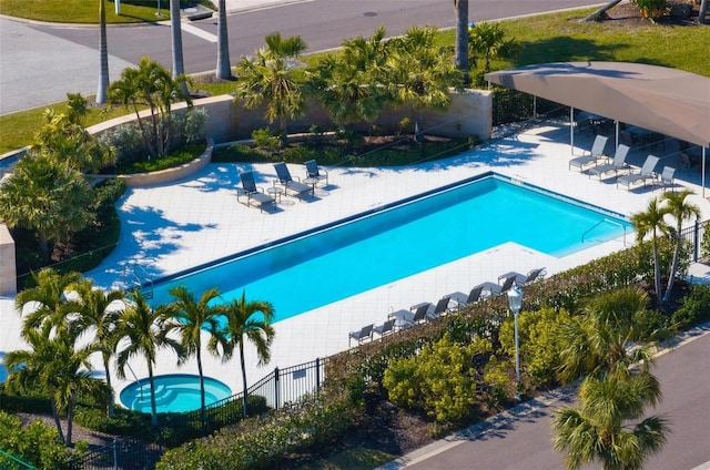 view of swimming pool featuring a community hot tub and a patio