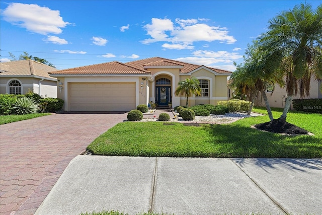 mediterranean / spanish-style house featuring a garage and a front yard