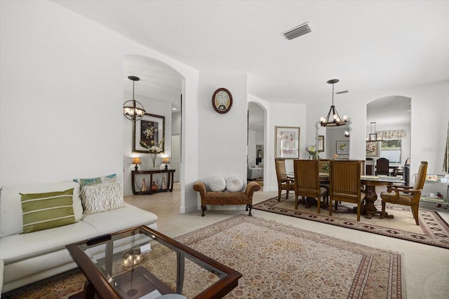 living room featuring a textured ceiling and an inviting chandelier