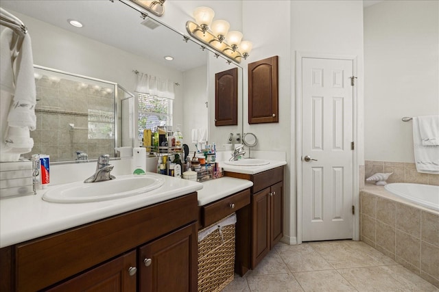 bathroom featuring independent shower and bath, vanity, and tile patterned flooring