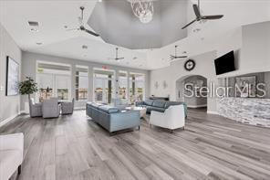 interior space featuring wood-type flooring and ceiling fan with notable chandelier