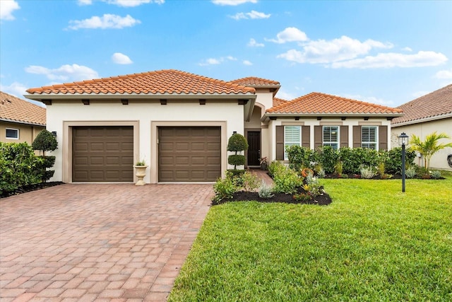 mediterranean / spanish-style house with a garage and a front lawn