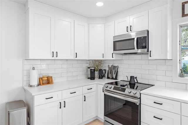 kitchen featuring white cabinetry and appliances with stainless steel finishes