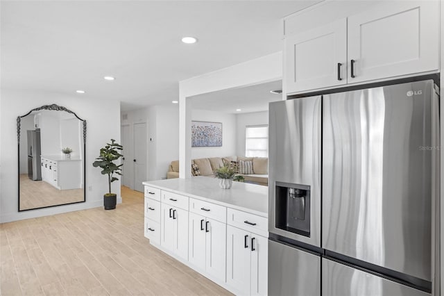 kitchen featuring white cabinetry, stainless steel refrigerator with ice dispenser, and light hardwood / wood-style floors