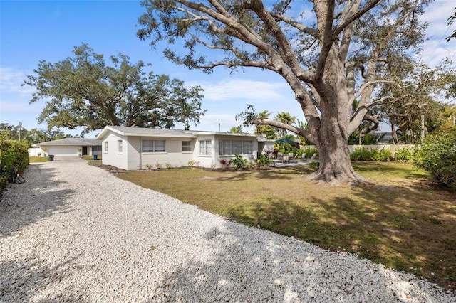 single story home with a garage and a front yard