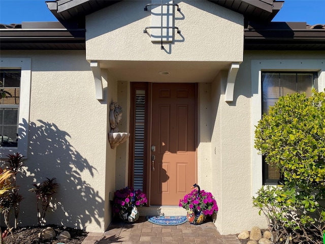 entrance to property with stucco siding