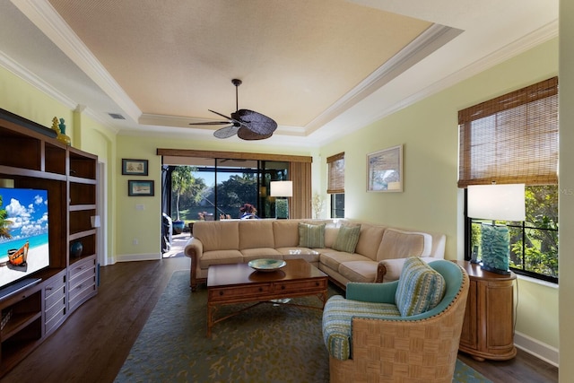 living room featuring dark wood-style floors, a raised ceiling, visible vents, and crown molding