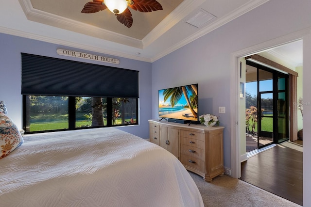 bedroom with visible vents, a ceiling fan, ornamental molding, access to exterior, and a tray ceiling