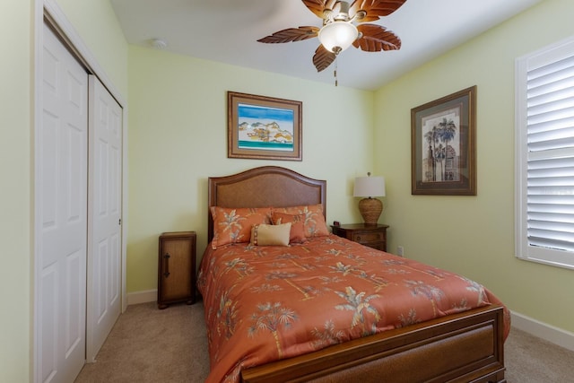 bedroom featuring a closet, light carpet, and baseboards