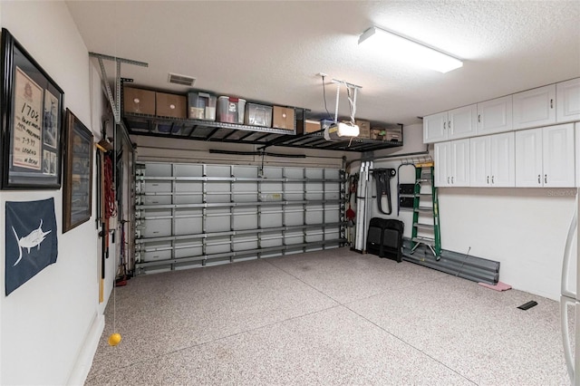 garage featuring visible vents and a garage door opener