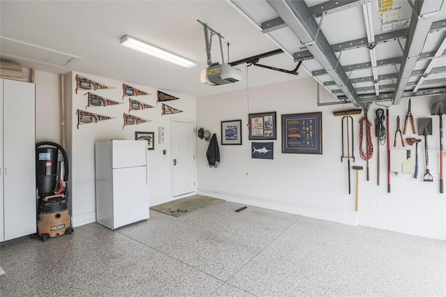 garage with a garage door opener and freestanding refrigerator