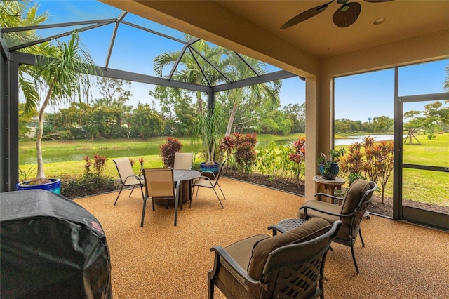 sunroom with a water view and a ceiling fan