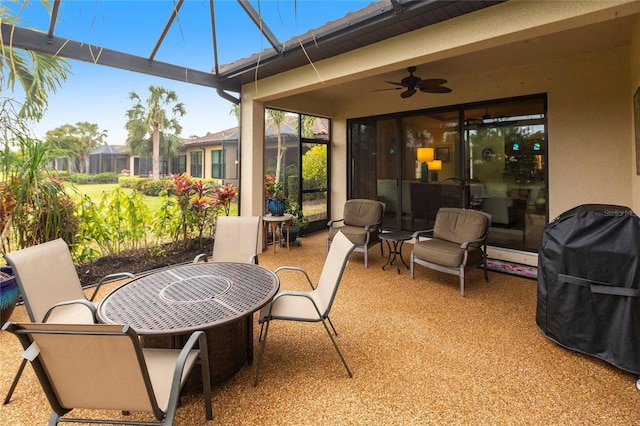 view of patio featuring ceiling fan and a lanai