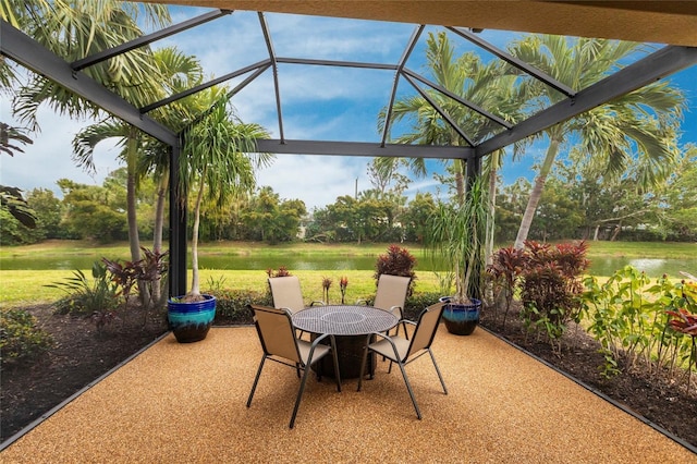 view of patio featuring glass enclosure and outdoor dining space