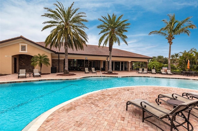 community pool with a patio area