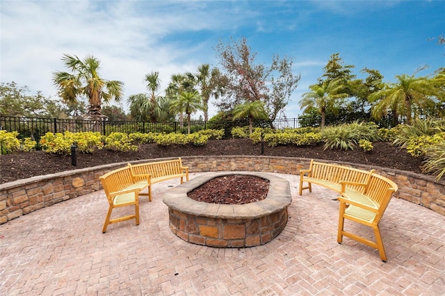 view of patio / terrace with fence and a fire pit