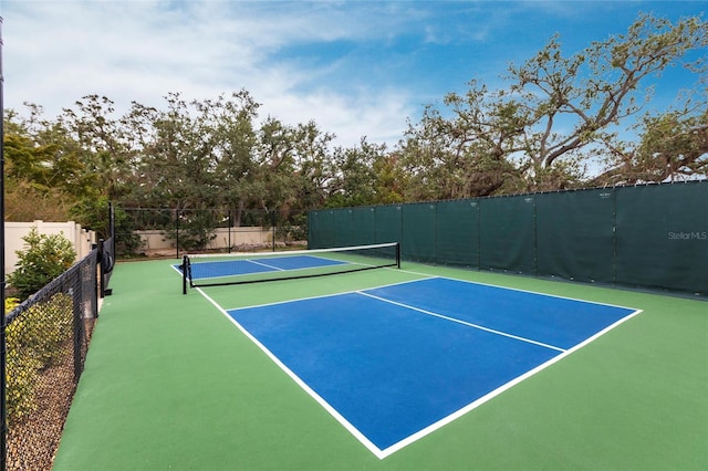 view of tennis court with fence