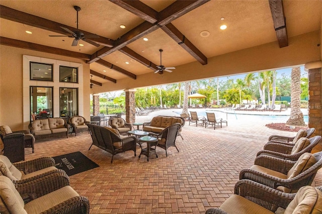 view of patio / terrace with outdoor lounge area, a ceiling fan, and a community pool