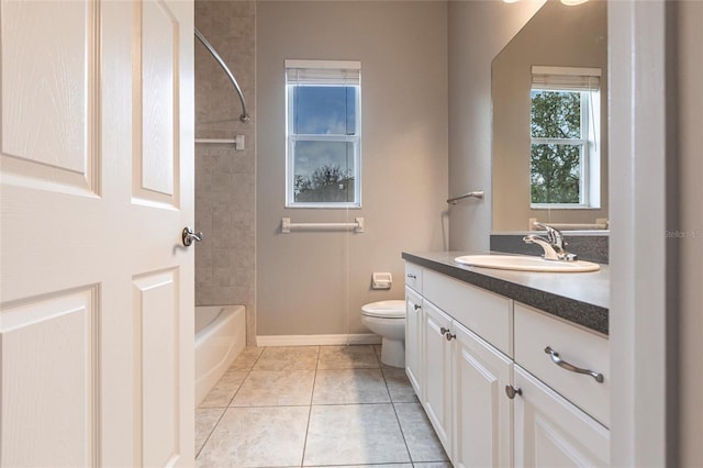 bathroom with baseboards, vanity, toilet, and tile patterned floors