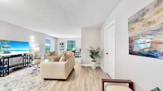 living room featuring a textured ceiling and light wood-type flooring