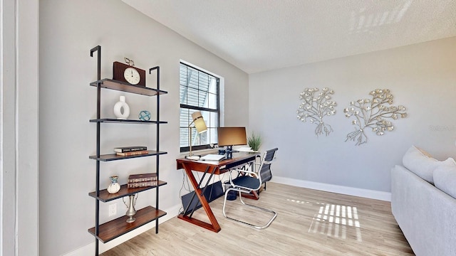 office space with light hardwood / wood-style floors and a textured ceiling