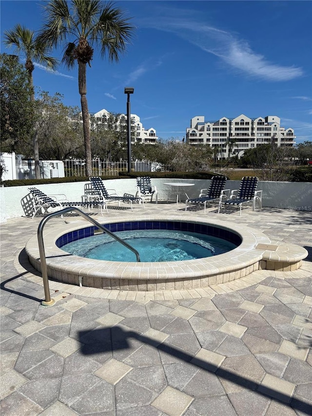 view of pool with a community hot tub and a patio