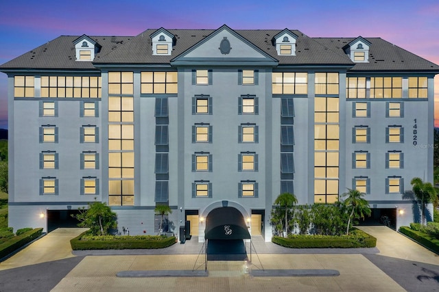 view of outdoor building at dusk