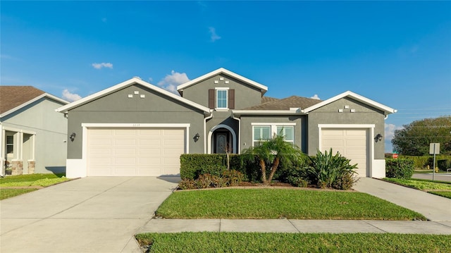 view of front of house with a garage and a front lawn