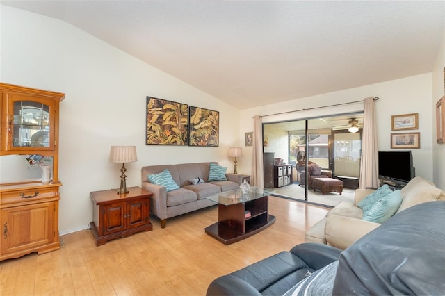 living room featuring light hardwood / wood-style flooring and vaulted ceiling