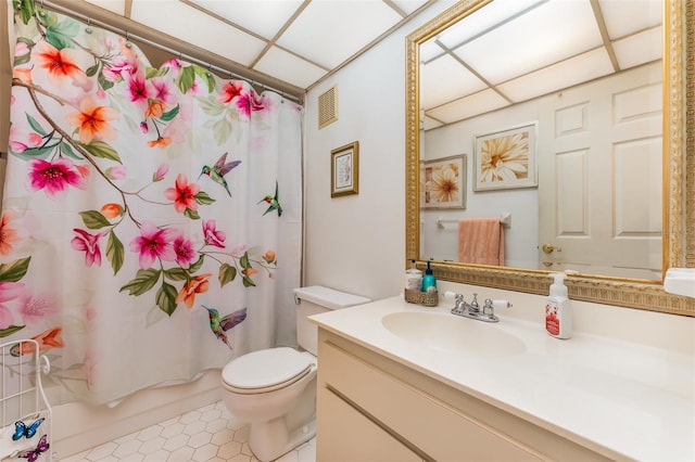 bathroom featuring a paneled ceiling, vanity, and toilet