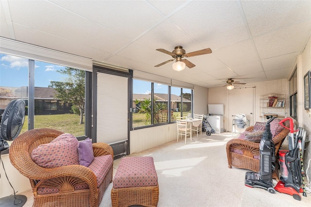 sunroom / solarium with a drop ceiling, a wealth of natural light, and ceiling fan