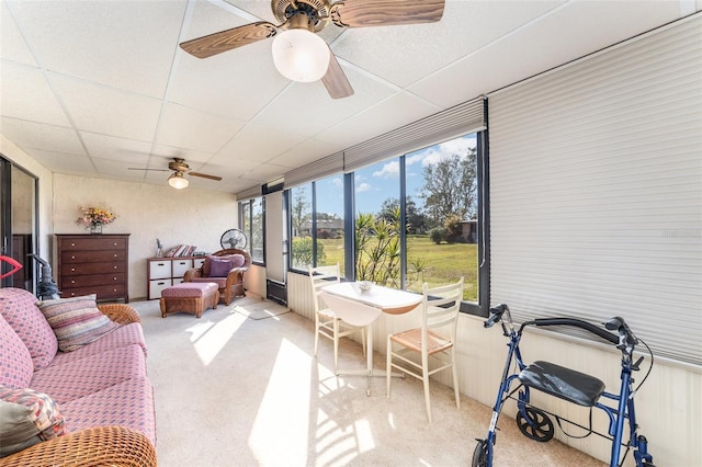 sunroom / solarium featuring ceiling fan and a paneled ceiling