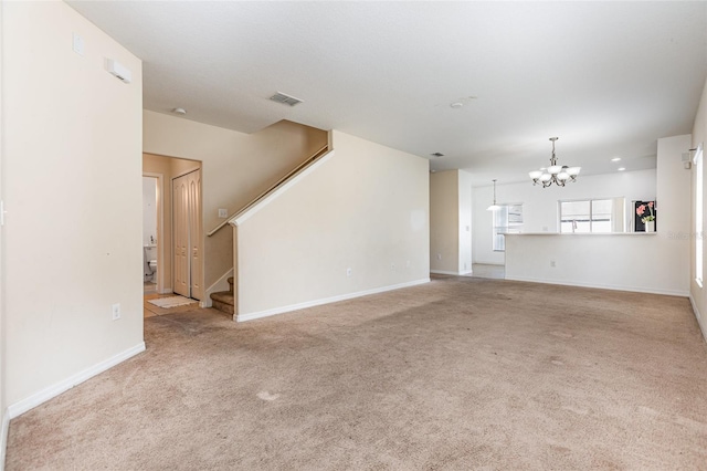 unfurnished living room with carpet, visible vents, stairway, a chandelier, and baseboards