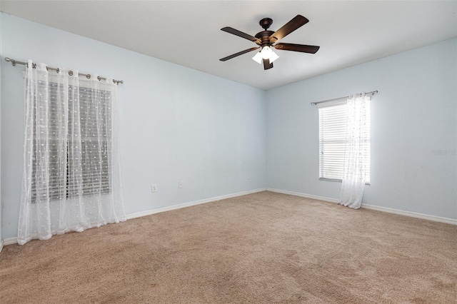 empty room featuring a ceiling fan, baseboards, and carpet flooring