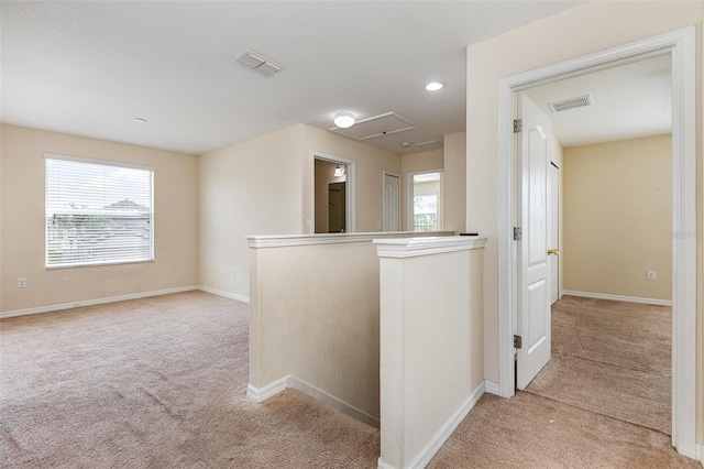 carpeted empty room with baseboards, visible vents, and recessed lighting