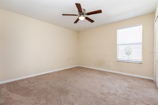 spare room featuring ceiling fan, baseboards, and carpet flooring