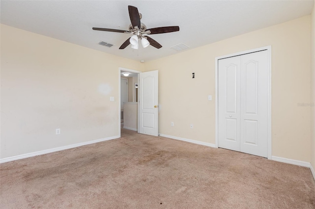 unfurnished bedroom featuring visible vents, a closet, baseboards, and carpet flooring