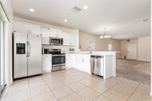 kitchen featuring a peninsula, light tile patterned floors, visible vents, and appliances with stainless steel finishes