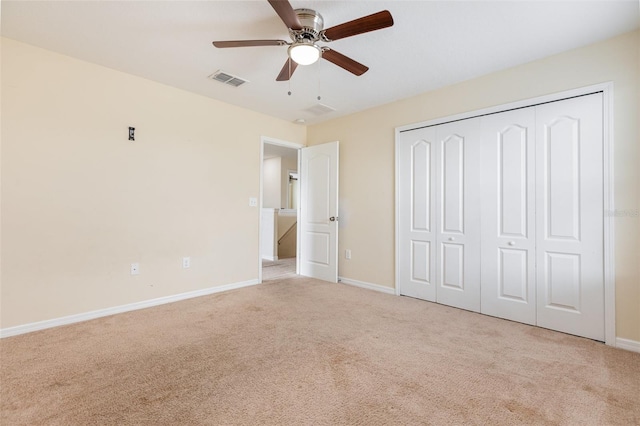 unfurnished bedroom featuring carpet, a closet, visible vents, and baseboards