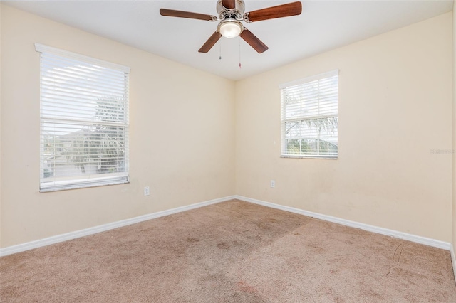 unfurnished room featuring a ceiling fan, carpet, and baseboards