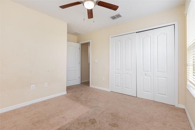 unfurnished bedroom with carpet floors, a ceiling fan, visible vents, baseboards, and a closet