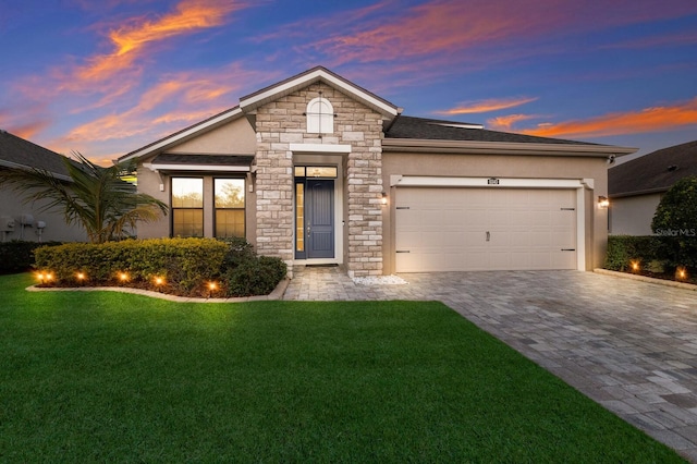 view of front facade with a yard and a garage