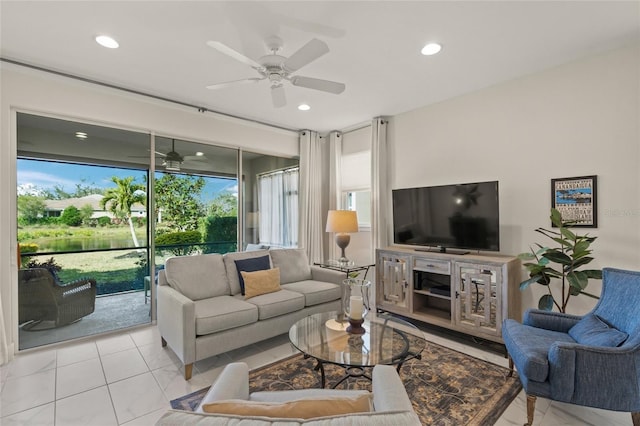 living room with light tile patterned flooring, a wealth of natural light, and ceiling fan