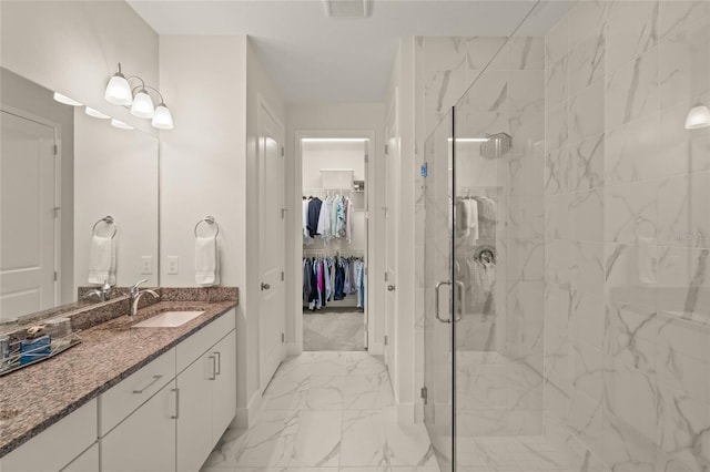 bathroom with walk in shower and vanity