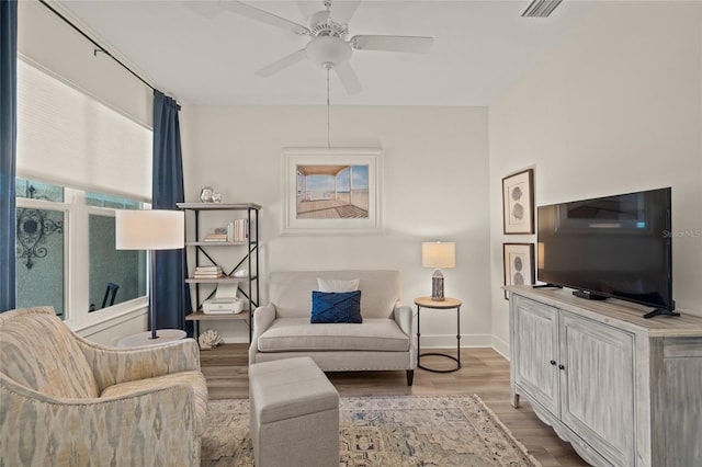 living room with hardwood / wood-style floors and ceiling fan